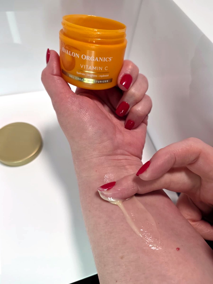 Holding the open jar with a little of the gel-cream on my arm