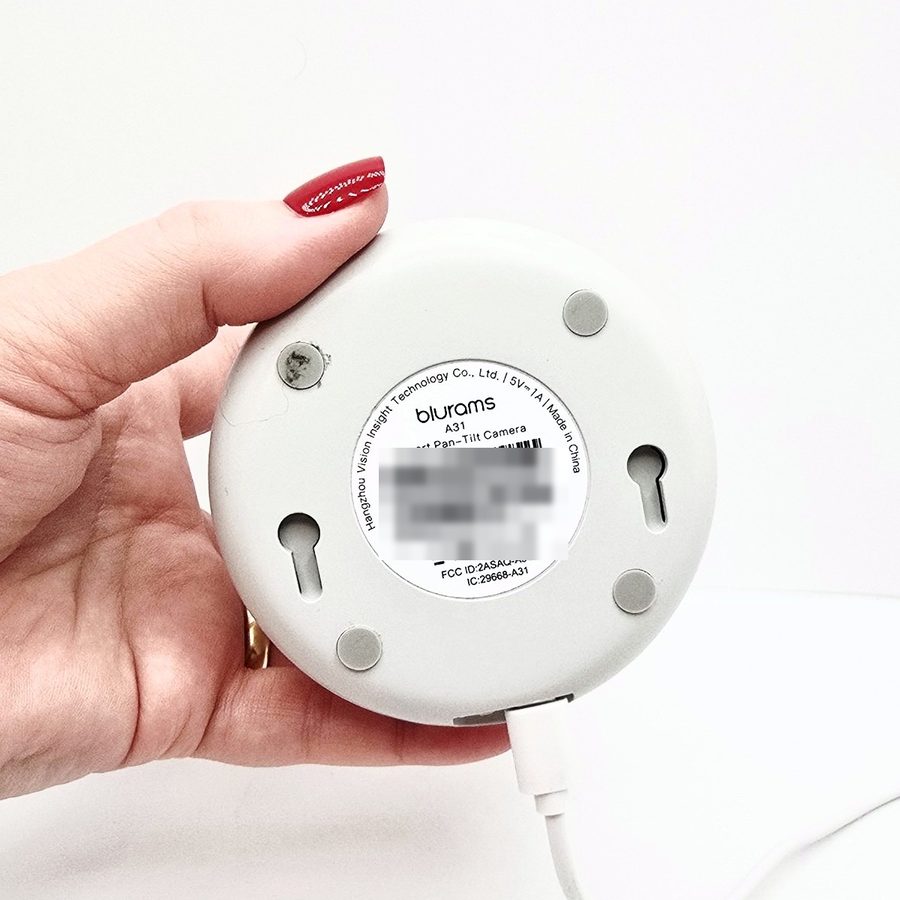 The bottom of the camera showing the model label and wall-mount slots