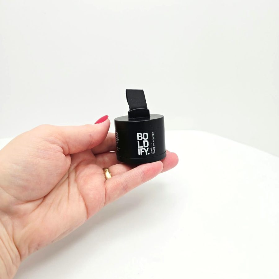 My hand holding my closed Boldify Hairline Powder