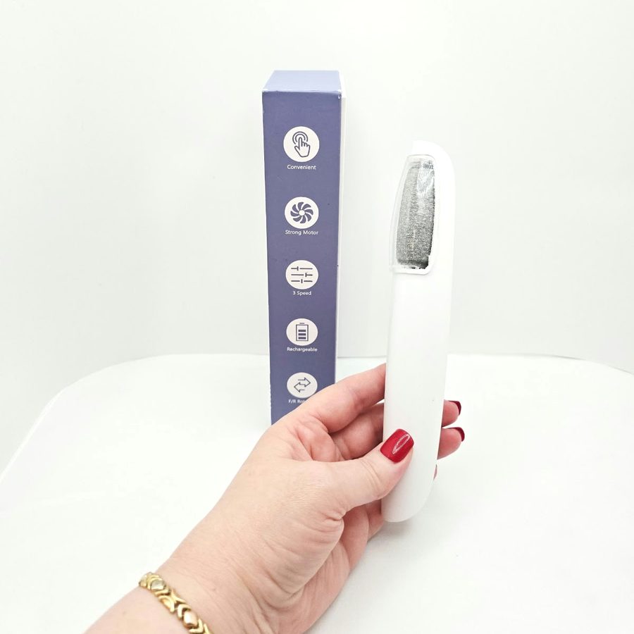 My hand holding the callus remover next to the side of the box