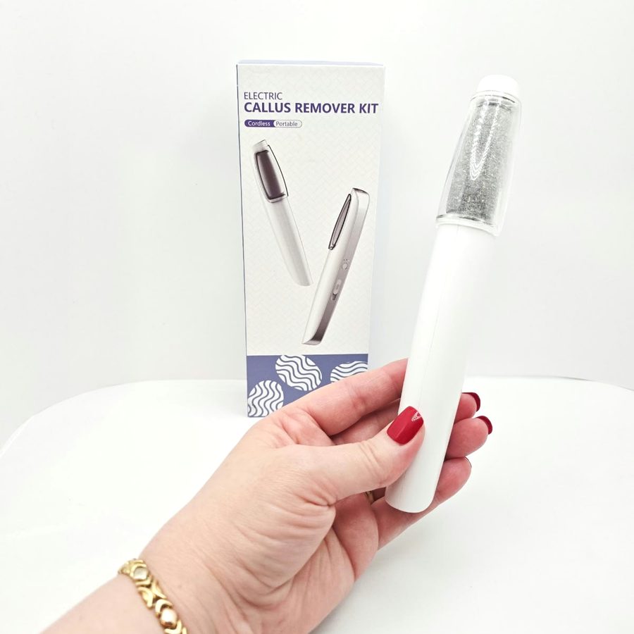 The callus remover in my hand with the clear cap over the roller
