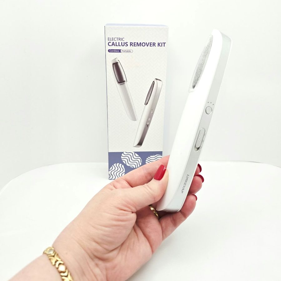 Side view of the callus remover in my hand, showing the power button and speed switch