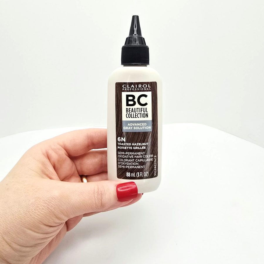 My hand holding my Clairol Advanced Gray Solution 6N bottle