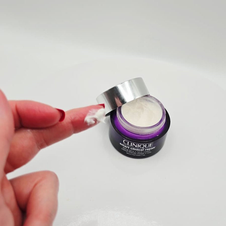 A little Clinique Smart Clinical Repair cream on my fingertip, next to the open jar