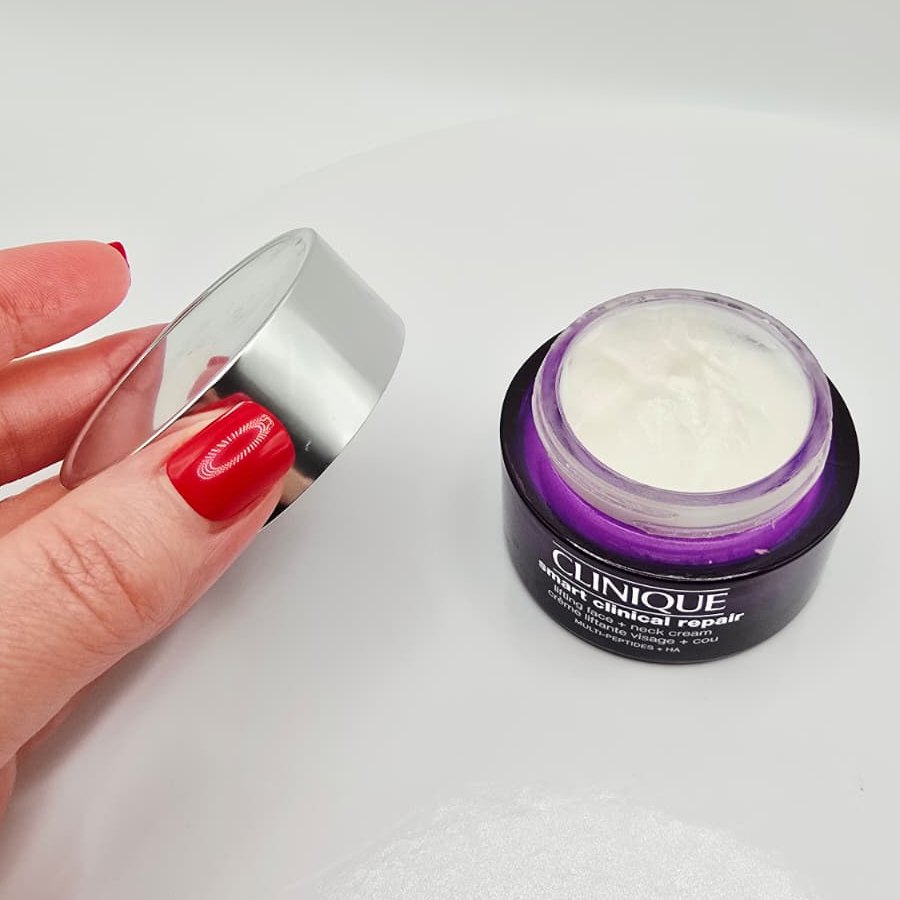 The Clinique Smart Clinical Repair jar open, showing the white cream, with the silver lid in my hand