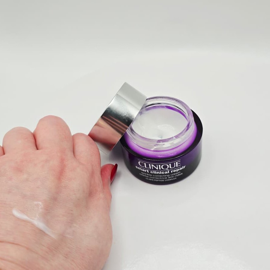 A swipe of Clinique Wrinkle Correcting Cream on the back of my hand, next to the open jar