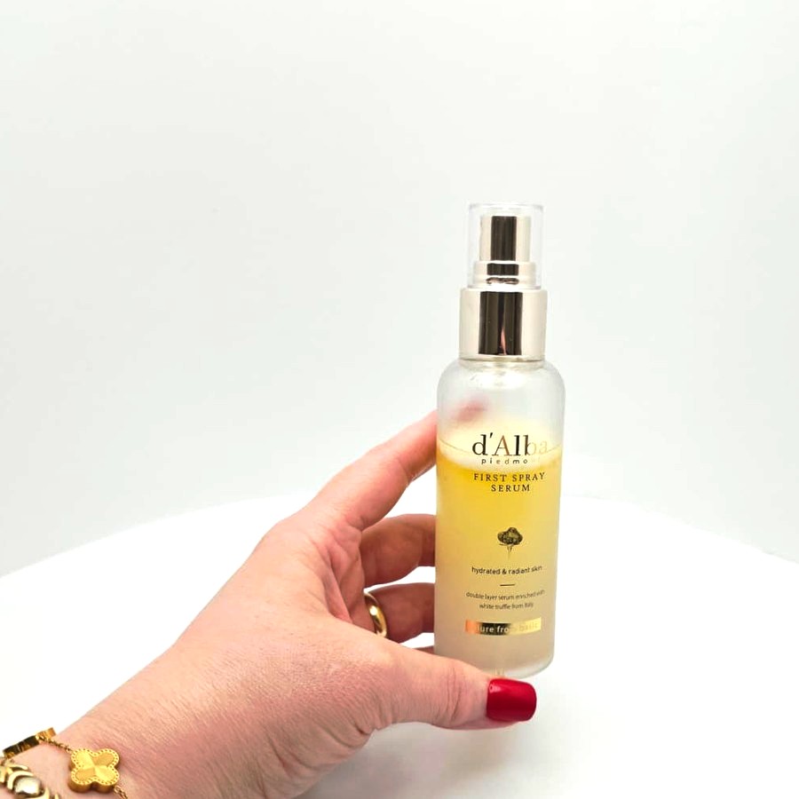 My hand holding my d'Alba First Spray Serum