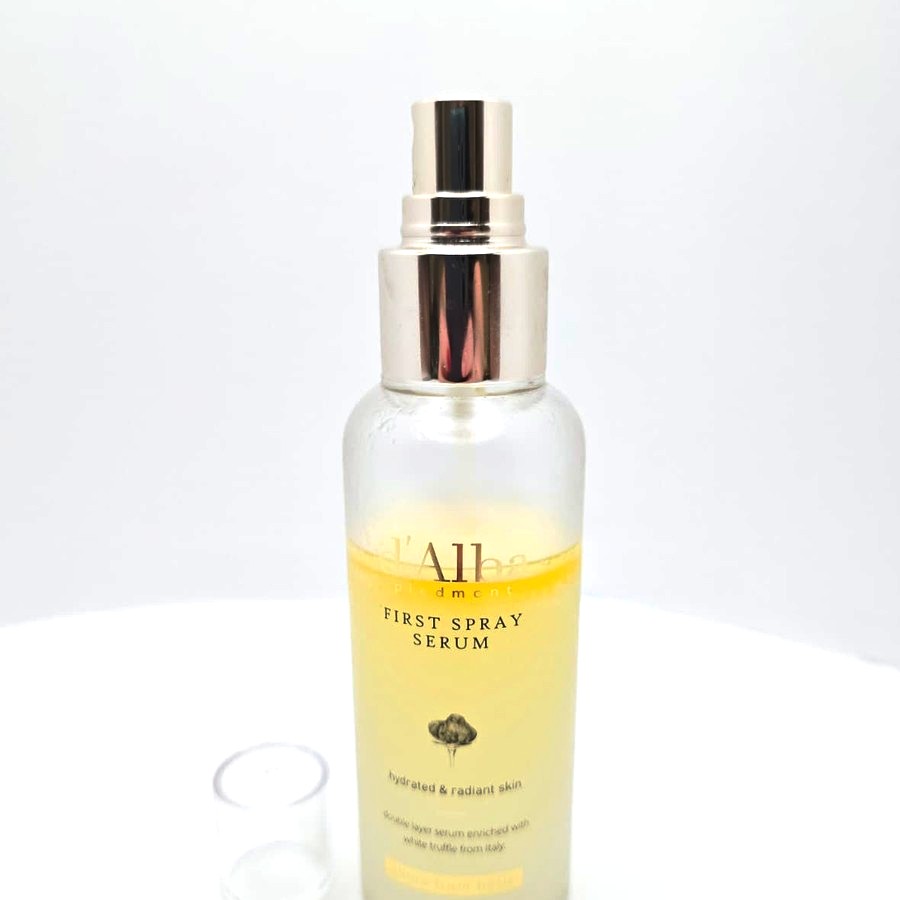 My d'Alba First Spray Serum with the cap off, showing the two layers