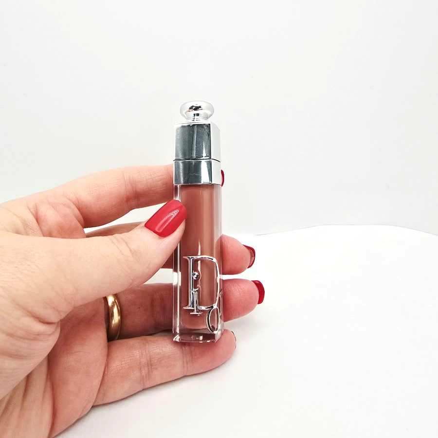 My hand holding my Dior Addict Lip Maximizer gloss