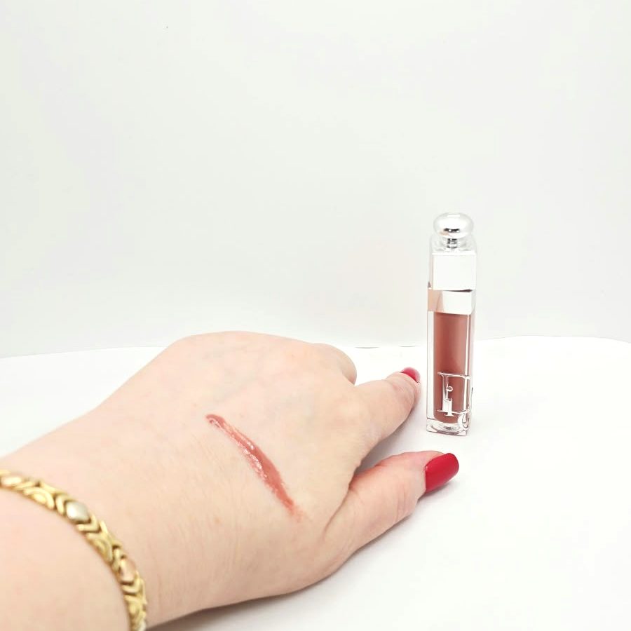 A swatch of Dior 013 Beige on the back of my hand, next to the gloss