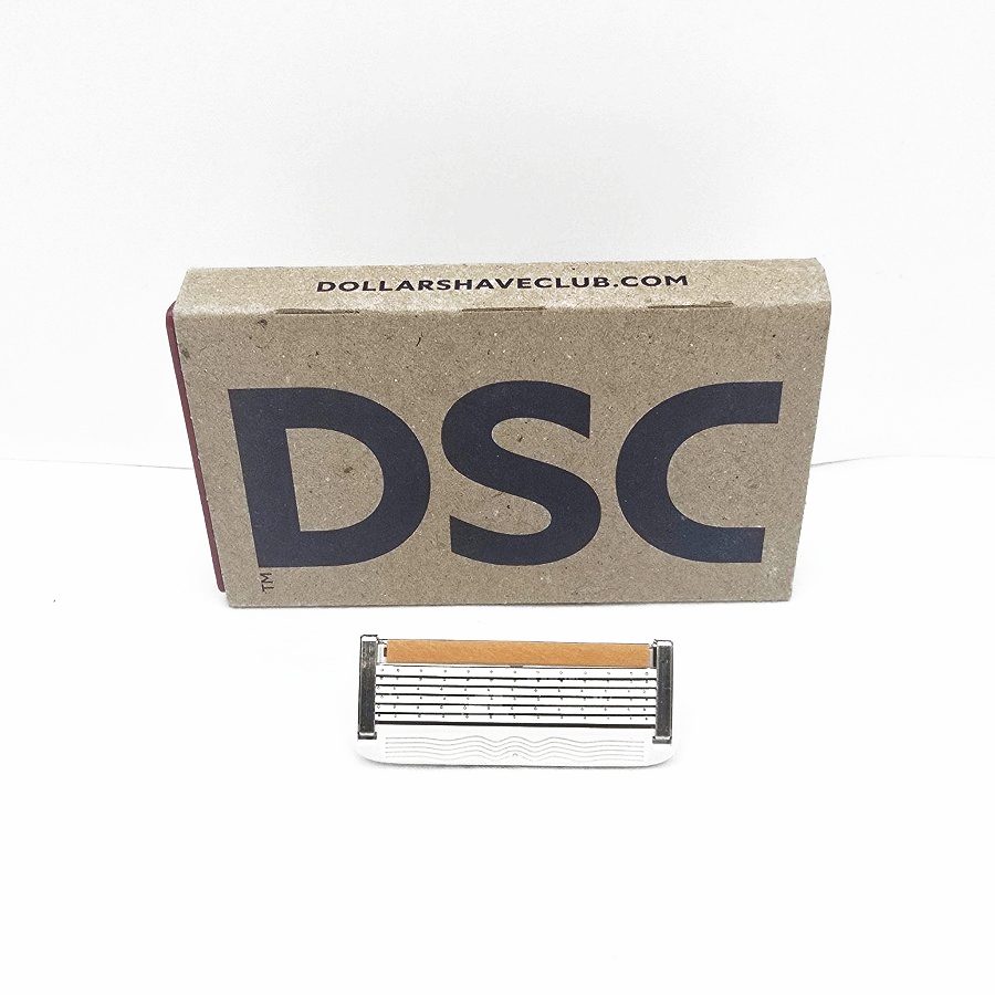 The cartridge lying in front of the Dollar Shave Club box