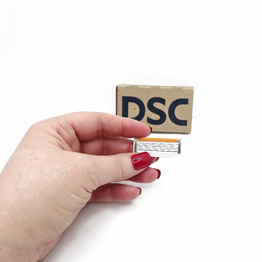 Close-up of the cartridge in my hand with the DSC box behind
