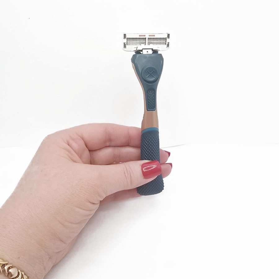 My hand holding the complete razor