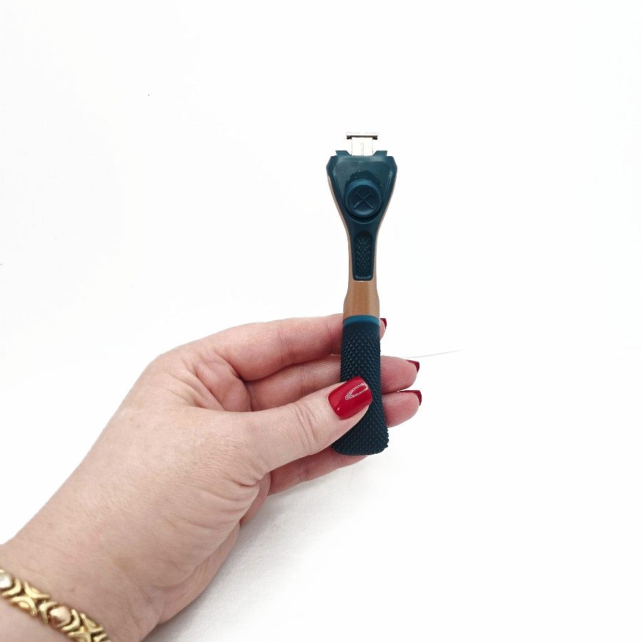 My hand holding the handle from the back, showing the release button near the top
