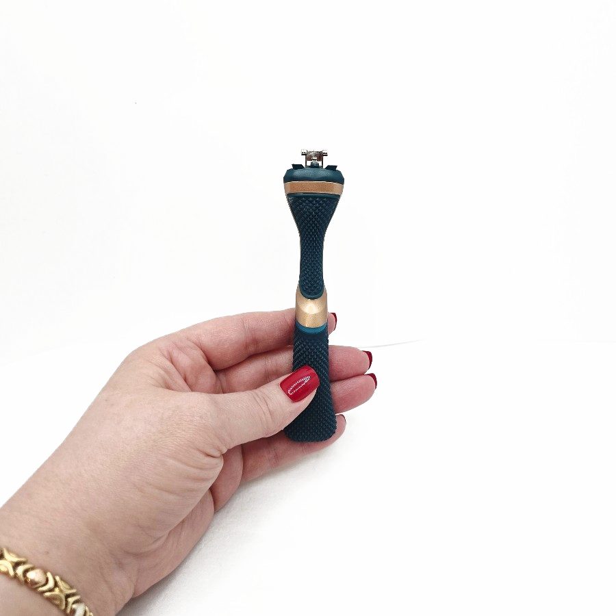 My hand holding the Dollar Shave Club handle, showing the textured diamond grip