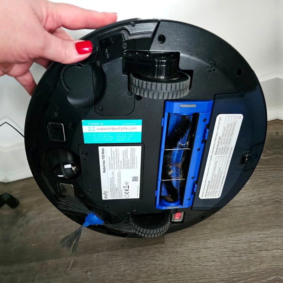 The underside of my eufy RoboVac 11S MAX, showing the brush roll, side brush and wheels