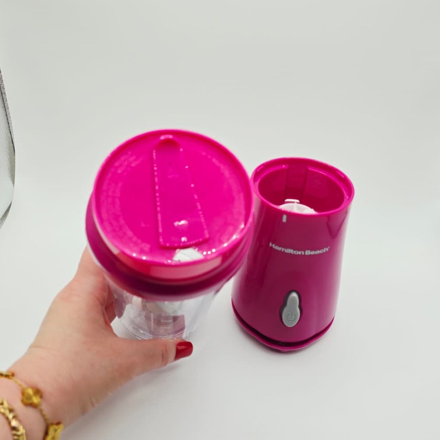 Holding my blender jar with the pink travel lid on, next to the base