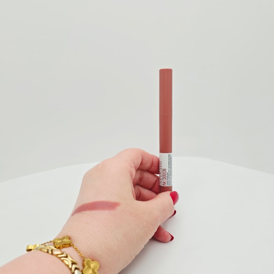 A swatch of my Maybelline Super Stay Ink Crayon in Lead The Way on the back of my hand while I hold the crayon