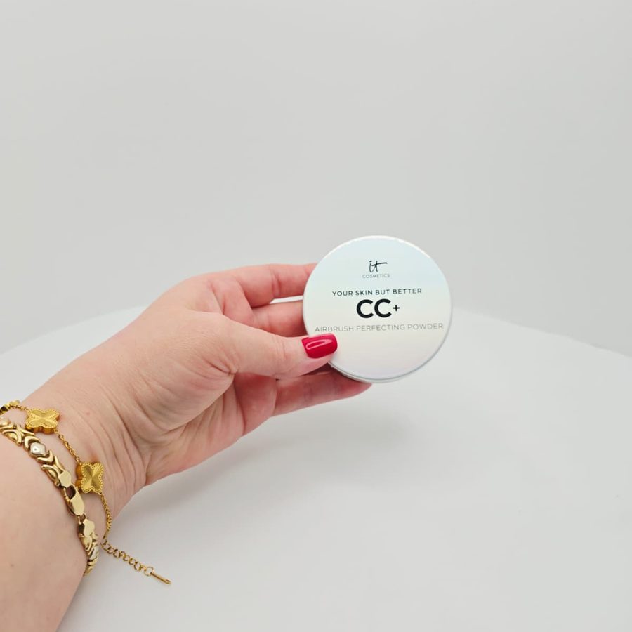 My hand holding the closed IT Cosmetics CC+ Airbrush Perfecting Powder