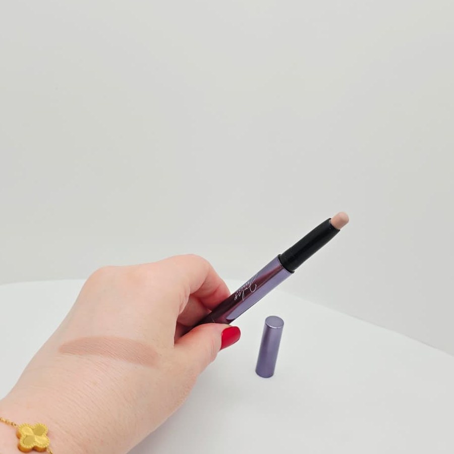 A swatch of my Julep Putty Matte eyeshadow stick on the back of my hand, next to the open stick
