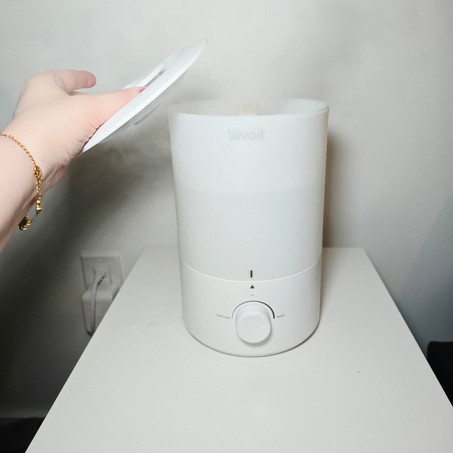 Lifting the lid off my Levoit humidifier on my nightstand to fill it from the top