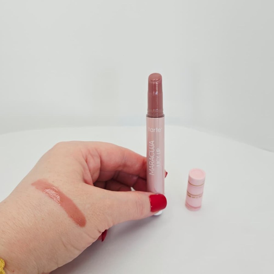 A swatch of my tarte Maracuja Juicy Lip in Vanilla King on the back of my hand, next to the open tube