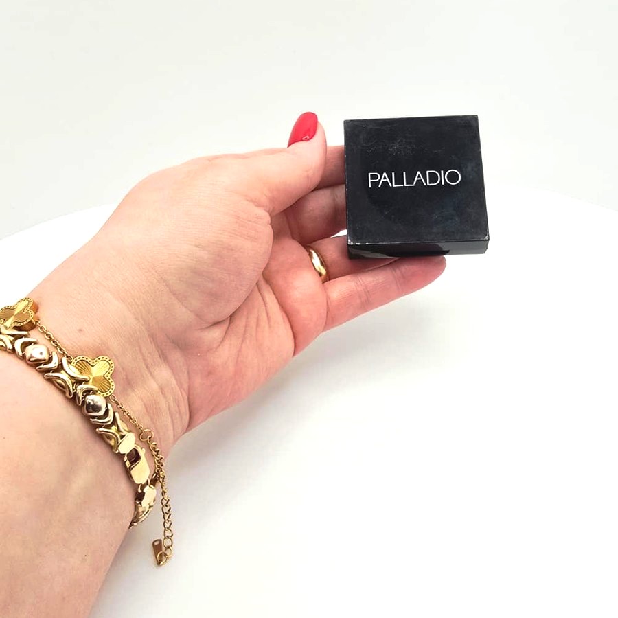 My hand holding my closed Palladio Under Eye Brightener compact