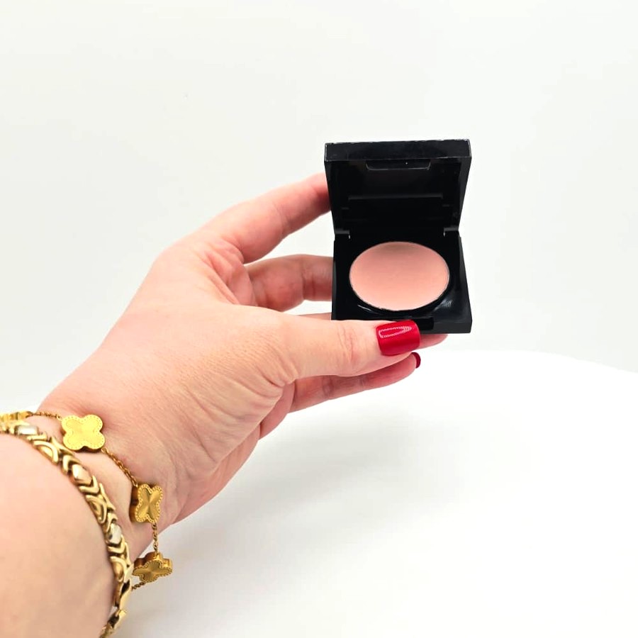 My hand holding the open compact showing the Soft Pink shade