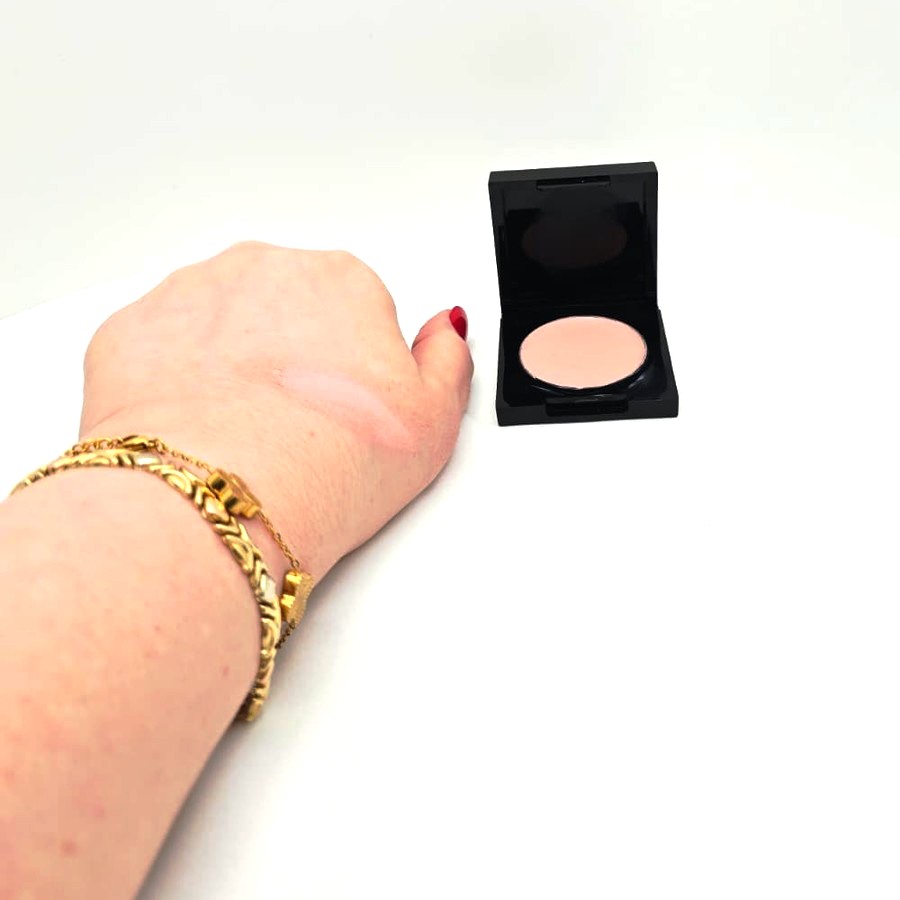 A swatch of Soft Pink on the back of my hand next to the open compact