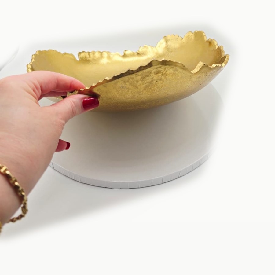 The side of the Red Co. gold bowl, showing its sculpted, irregular edge