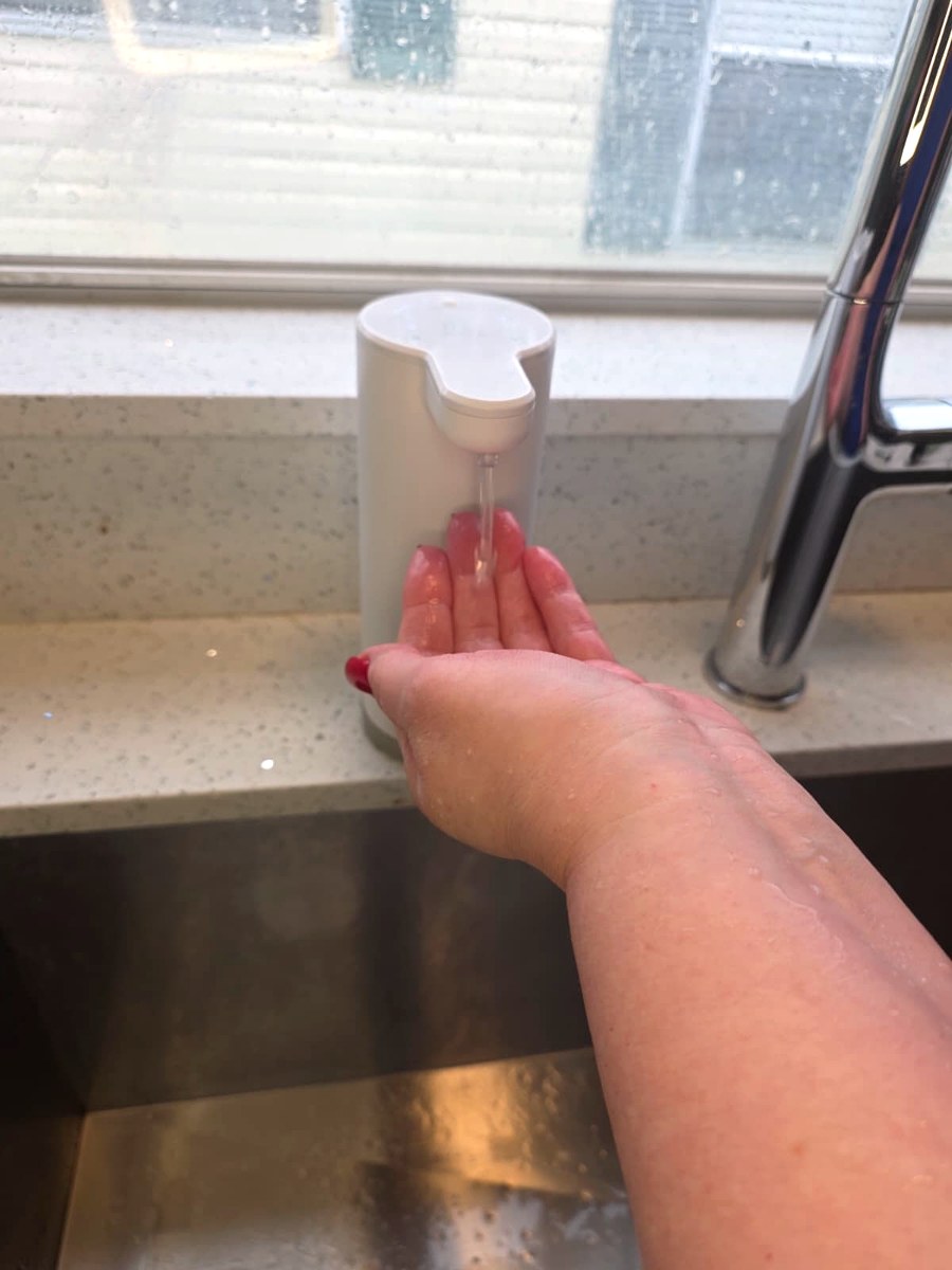 The Seawah automatic dispenser releasing foam onto my open hand