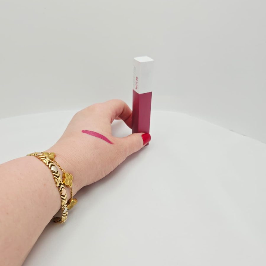 A swatch of shade Lover 15 on the back of my hand, next to the lipstick