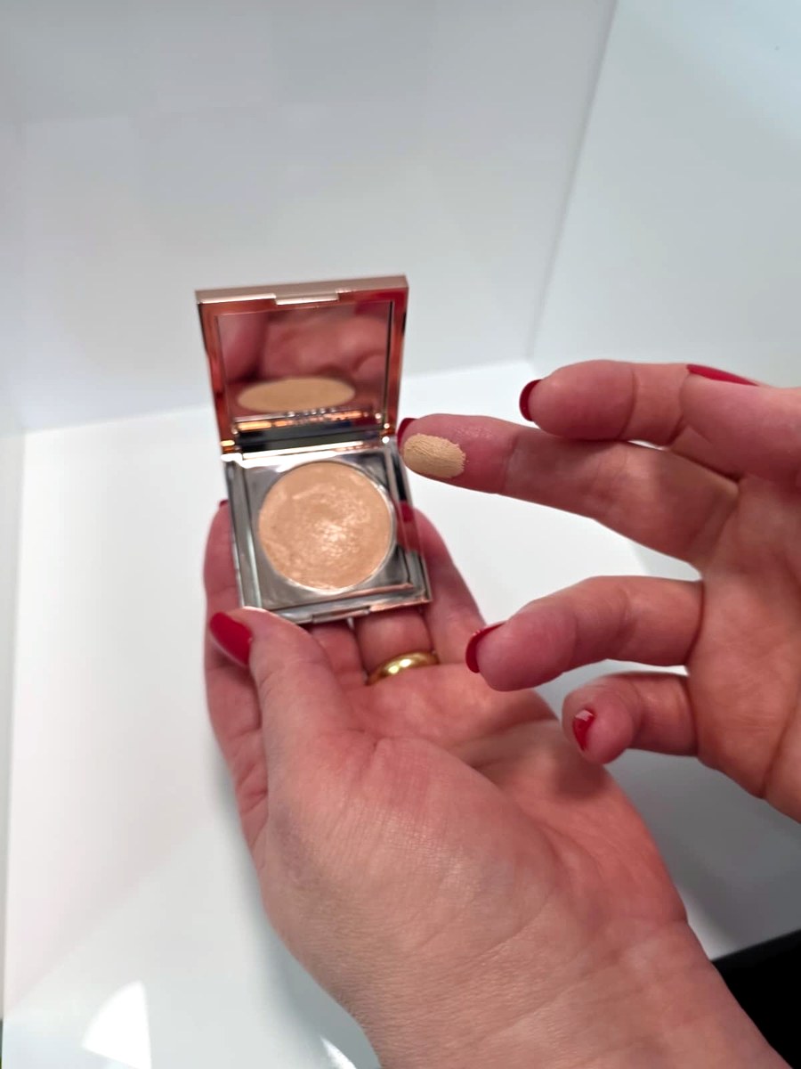 The Tarte Colored Clay CC undereye corrector open in my hand, showing the peach cream and the mirror