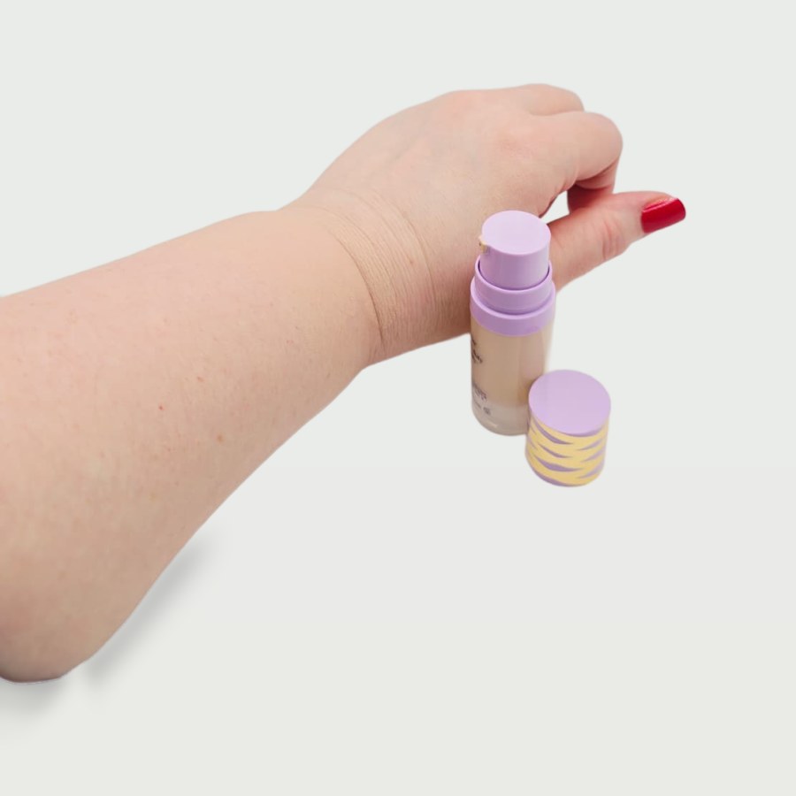 My tarte face tape foundation with the cap off, next to my hand