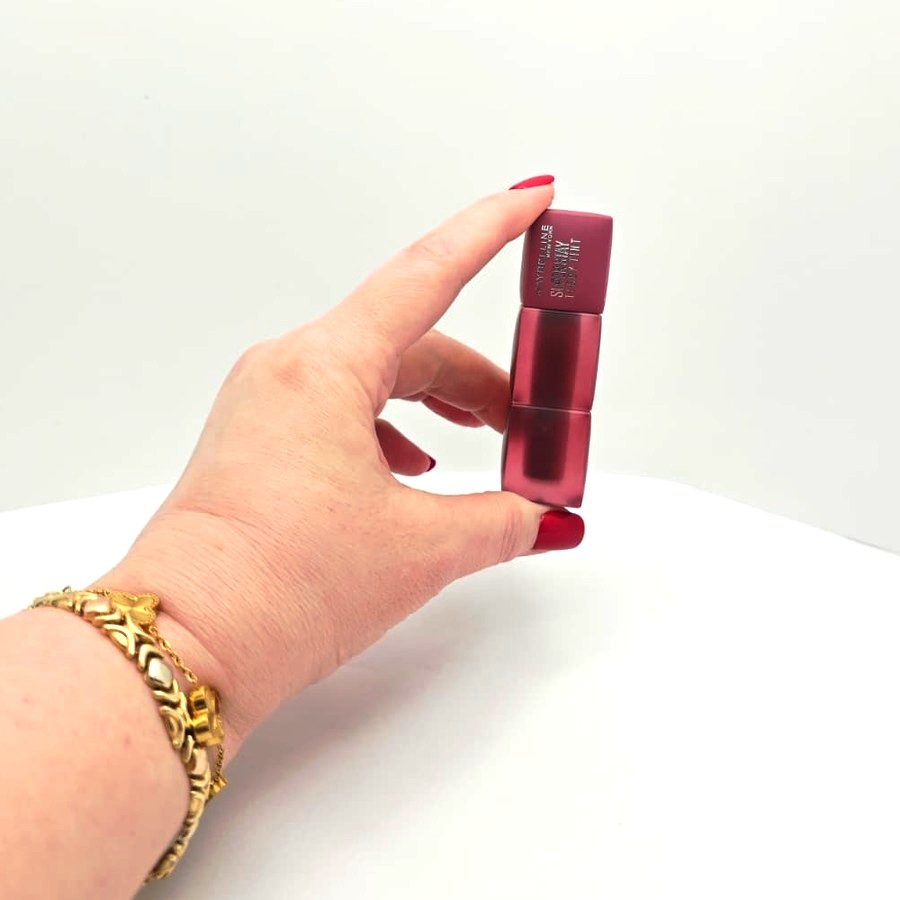 My hand holding my Maybelline Super Stay Teddy Tint in Endgame